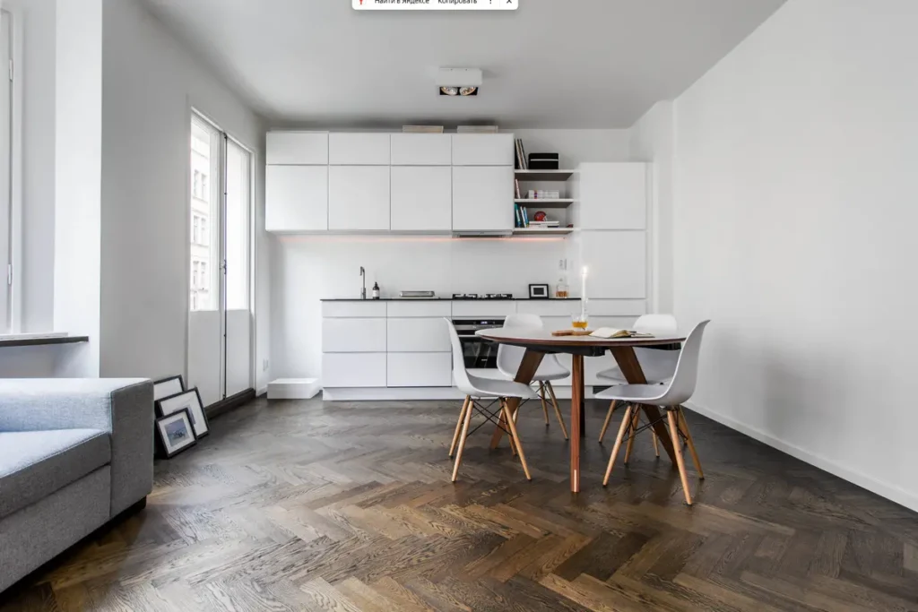 Ассиметричный кухонный гарнитур с белыми фасадами без ручек в стиле минимализм